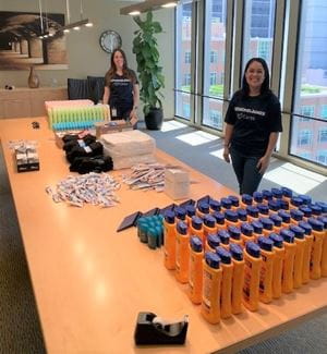 Jess Geller and Tatiana Fox pose with donated hygiene items